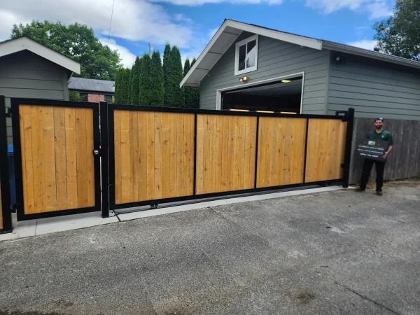 Wooden driveway gate installed and matching pedestrian gate