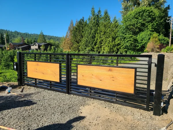 Decorative wooden fence gate with latch hardware and reinforced frame