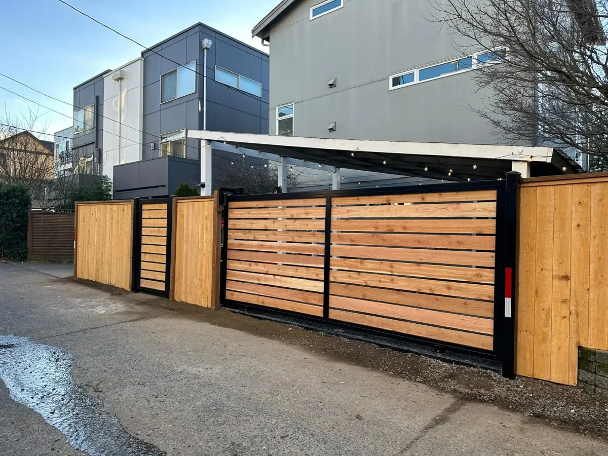 Wooden privacy driveway gate with horizontal slat design