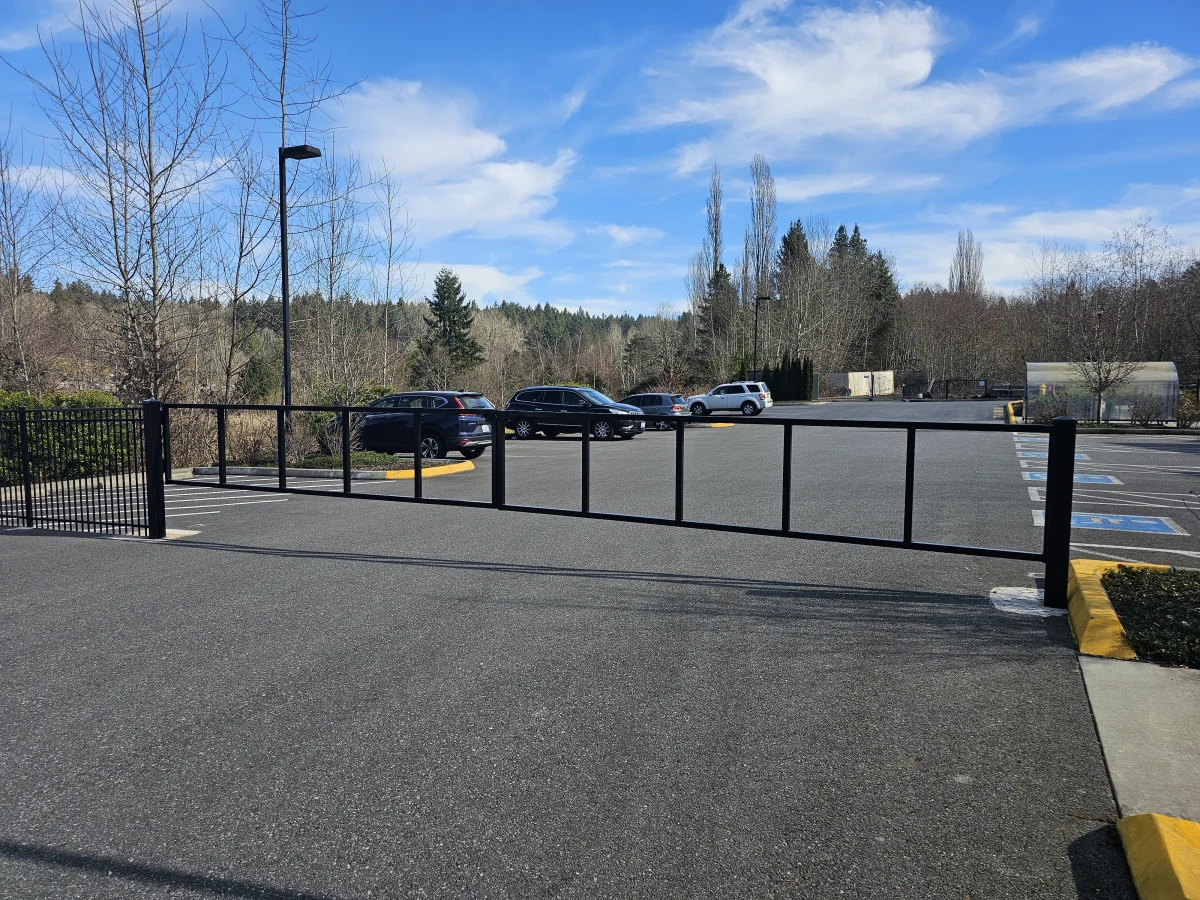 Parking lot barrier arm gate controlling vehicle access for commercial property
