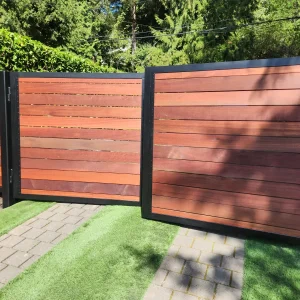 Double wooden driveway gates with natural stain finish and steel frame support