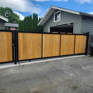Wooden driveway gate installed and matching pedestrian gate