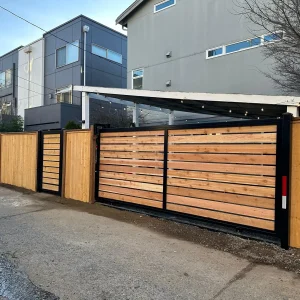 Wooden privacy driveway gate with horizontal slat design
